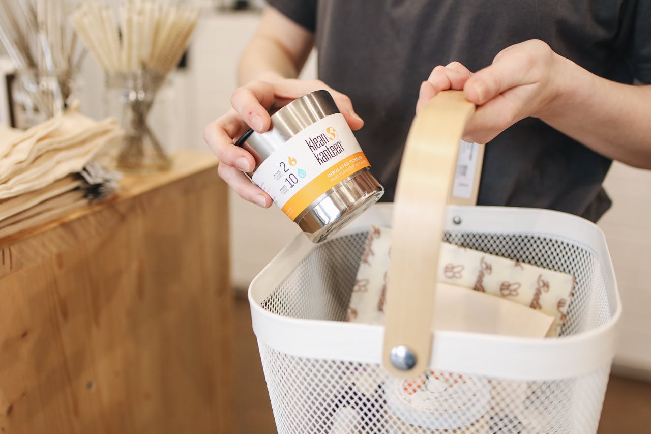 A person shopping in an eco-friendly store using reusable items and a shopping basket.