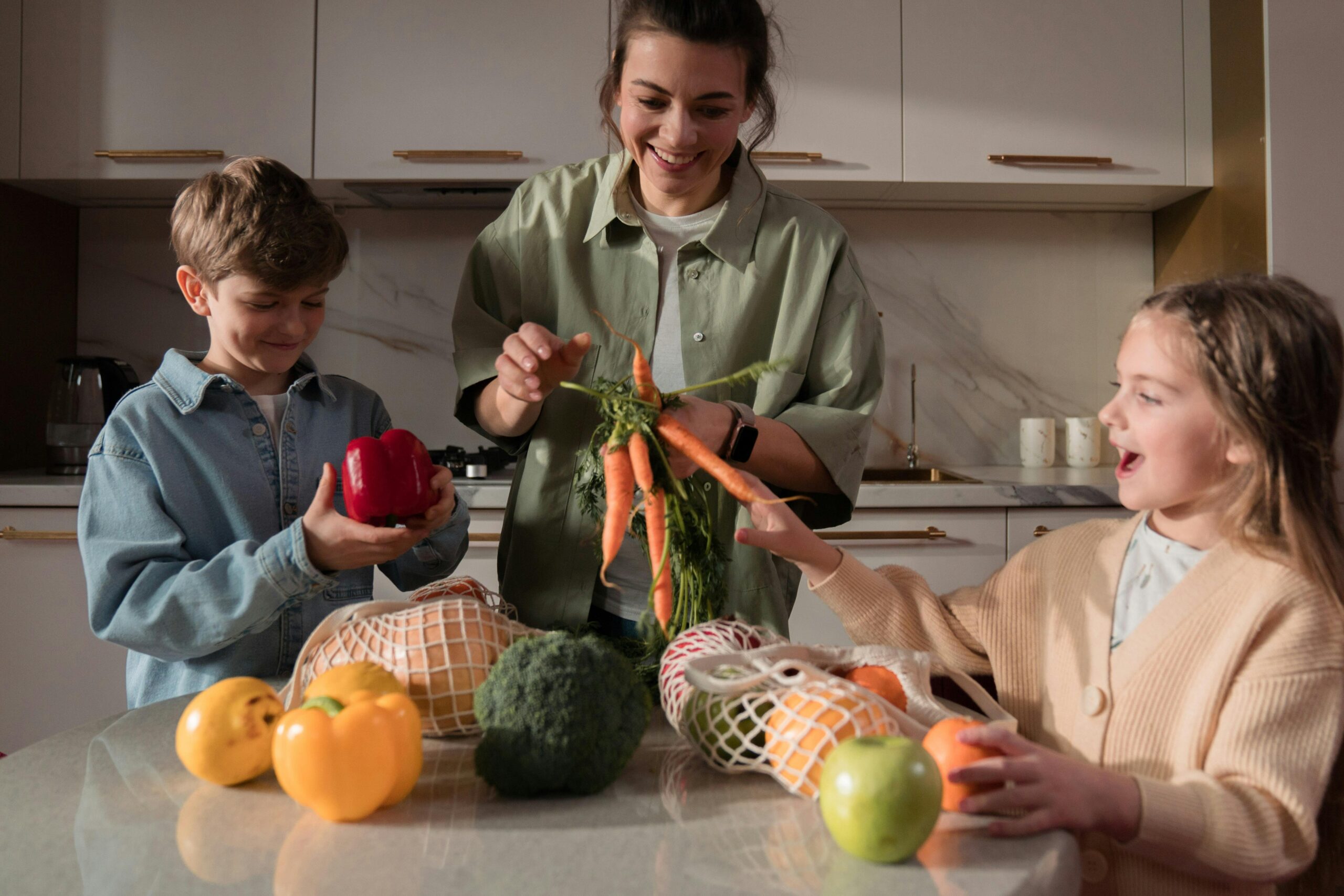 A family enjoys quality time in the kitchen, preparing a meal with fresh vegetables.