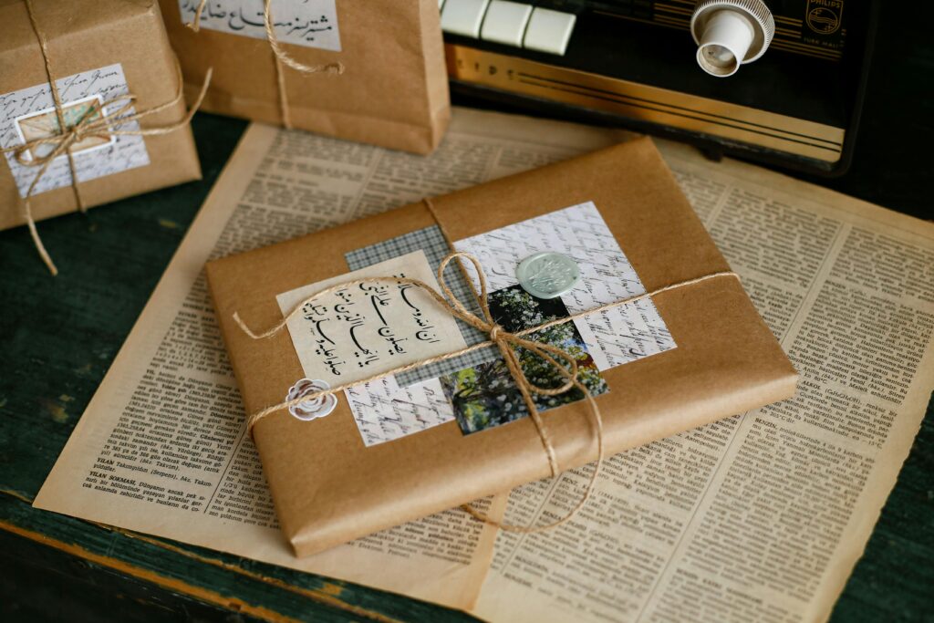 Beautifully wrapped gifts with vintage tags overlaid on an old newspaper. Perfect for a nostalgic presentation.